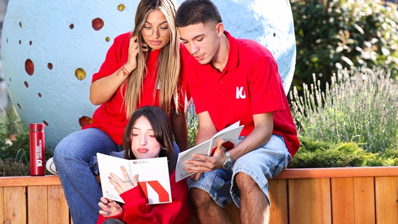 A teen holding a globe.